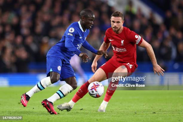 Ngolo Kante of Chelsea controls the ball while under pressure from Jordan Henderson of Liverpool during the Premier League match between Chelsea FC...