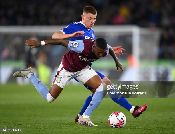 Ashley Young of Aston Villa is tackled by Harvey Barnes of Leicester City during the Premier League match between Leicester City and Aston Villa at...