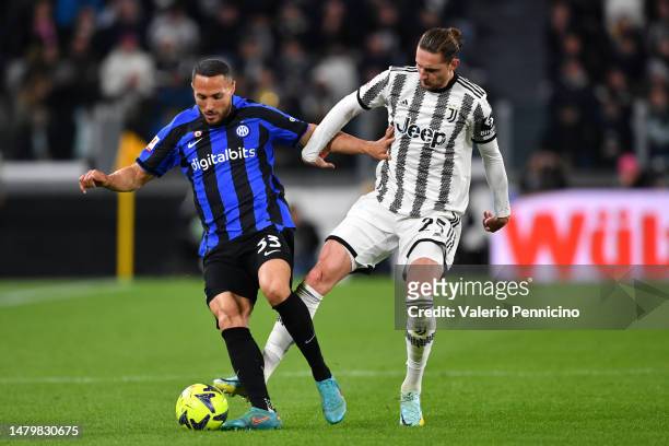 Danilo D'Ambrosio of FC Internazionale is challenged by Adrien Rabiot of Juventus during the Coppa Italia Semi Final match between Juventus FC and FC...