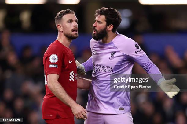 Alisson Becker of Liverpool clashes with teammate Jordan Henderson during the Premier League match between Chelsea FC and Liverpool FC at Stamford...