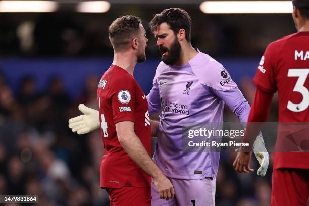 Jordan Henderson and Alisson Becker of Liverpool clash during the Premier League match between Chelsea FC and Liverpool FC at Stamford Bridge on...