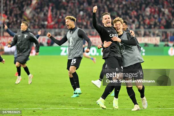 Christian Guenter of Sport-Club Freiburg celebrates with teammate Yannik Keitel after the team's victory in the DFB Cup quarterfinal match between FC...