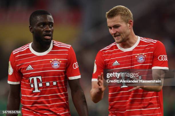 Matthijs de Ligt of FC Bayern Munich reacts alongside teammate Dayot Upamecano during the DFB Cup quarterfinal match between FC Bayern München and SC...