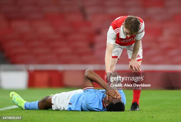 Isaiah Dada-Mascoll of of Manchester City is consoled by Jimi Gower of Arsenal after the FA Youth Cup Semi-Final match between Arsenal U18 and...