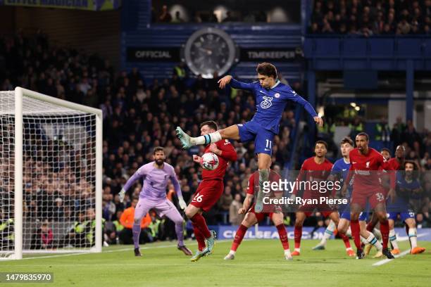 Joao Felix of Chelsea battles for possession with Andrew Robertson of Liverpool during the Premier League match between Chelsea FC and Liverpool FC...