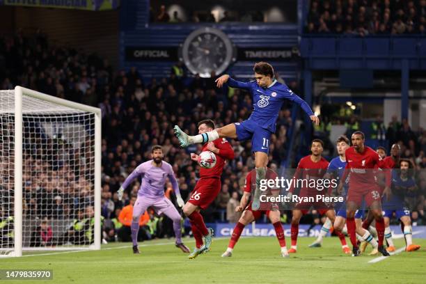 Joao Felix of Chelsea battles for possession with Andrew Robertson of Liverpool during the Premier League match between Chelsea FC and Liverpool FC...