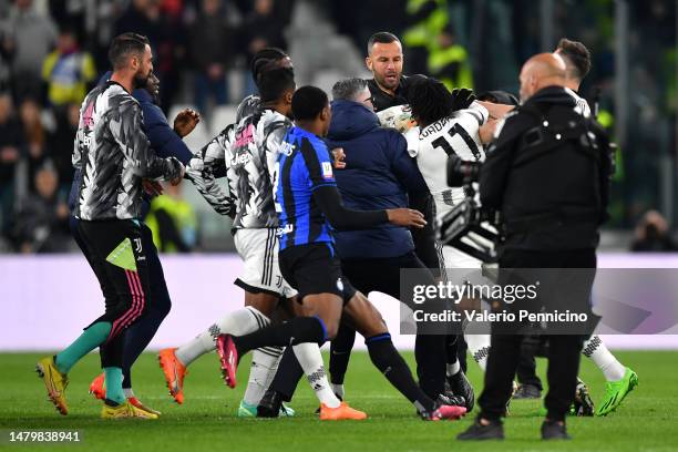 Samir Handanovic of FC Internazionale clashes with Juan Cuadrado of Juventus during the Coppa Italia Semi Final match between Juventus FC and FC...