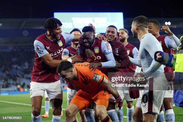 Bertrand Traore of Aston Villa celebrates with teammates on the back of Emiliano Martinez of Aston Villa after the team's victory in the Premier...