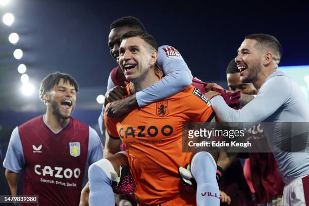 Bertrand Traore of Aston Villa celebrates on the back of teammate Emiliano Martinez of Aston Villa after the team's victory in the Premier League...