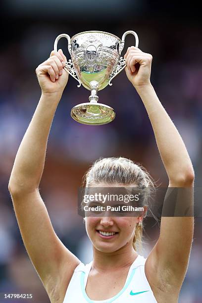 Eugenie Bouchard of Canada lifts the winners trophy after winning her Girls’ Singles final match against Elina Svitolina of Ukraine on day twelve of...