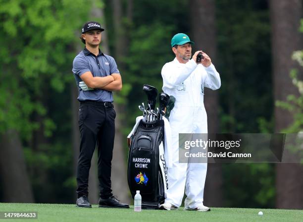 Harrison Crowe of Australia waits to play his second shot on the 11th hole with his caddie Andrew Tschudin during practice prior to the 2023 Masters...