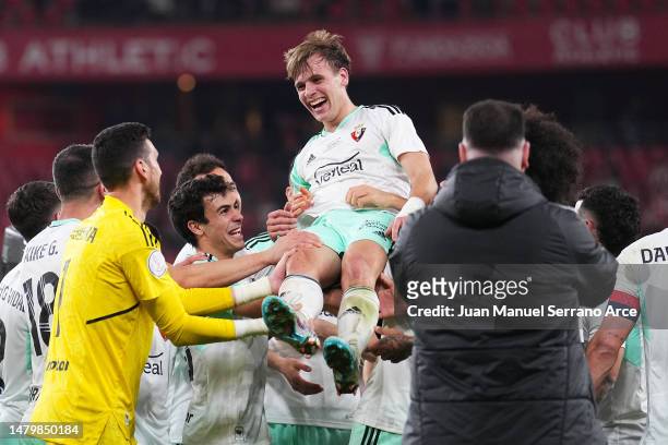 Pablo Ibanez of CA Osasuna is lifted by teammates in celebration following the Copa Del Rey Semi Final Second Leg match between Athletic Club and...