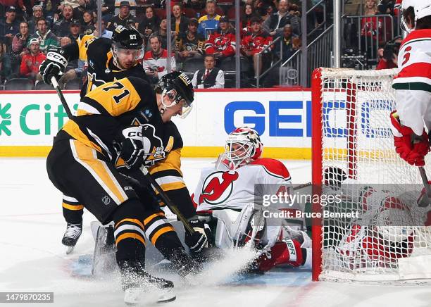 Vitek Vanecek of the New Jersey Devils makes the first period save on Sidney Crosby and Evgeni Malkin of the Pittsburgh Penguins at the Prudential...