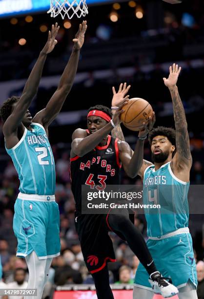 Pascal Siakam of the Toronto Raptors drives between JT Thor and Nick Richards of the Charlotte Hornets during the first half of the game at Spectrum...