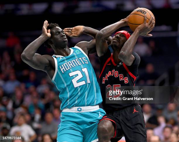 Chris Boucher of the Toronto Raptors drives to the basket against JT Thor of the Charlotte Hornets during the first half of the game at Spectrum...