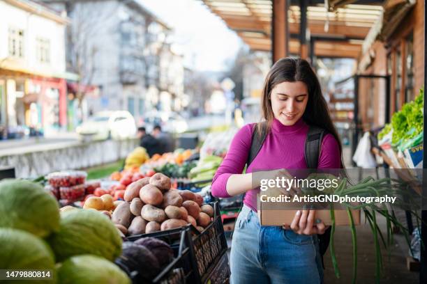 buying fresh groceries from a local small market. - colorful vegetables summer stock pictures, royalty-free photos & images