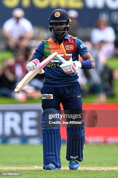 Pathum Nissanka of Sri Lanka inspects his broken bat during game two of the T20 International series between New Zealand and Sri Lanka at University...