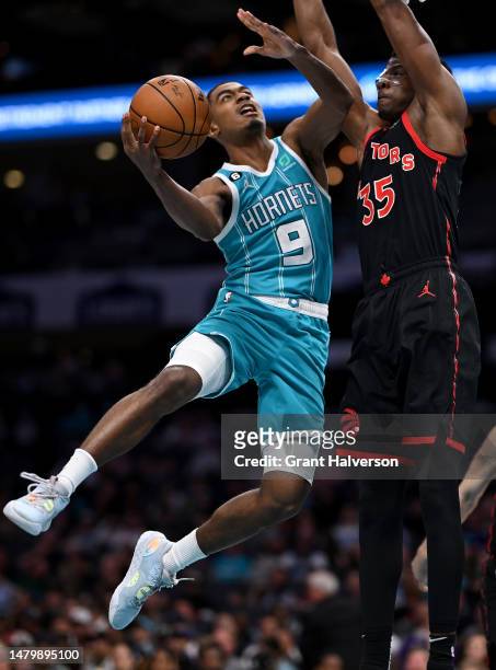 Theo Maledon of the Charlotte Hornets drives to the basket against Christian Koloko of the Toronto Raptors during the second half of the game at...