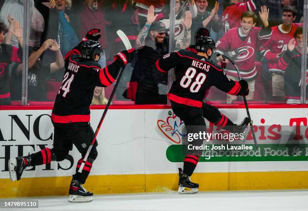 Martin Necas of the Carolina Hurricanes celebrates after scoring the game-winning goal in overtime against the Ottawa Senators at PNC Arena on April...