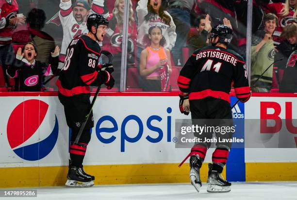 Martin Necas of the Carolina Hurricanes celebrates after scoring the game-winning goal in overtime against the Ottawa Senators at PNC Arena on April...