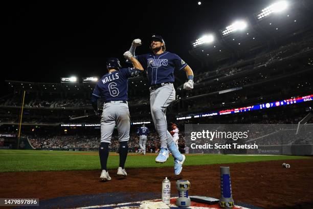 Josh Lowe of the Tampa Bay Rays celebrates his go-ahead solo home run with Taylor Walls against the Washington Nationals in the ninth inning at...