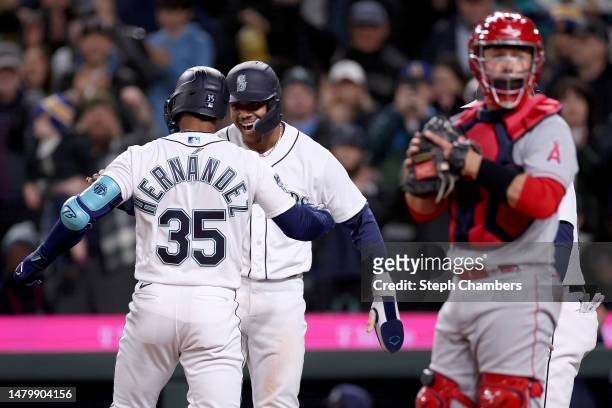 Julio Rodriguez of the Seattle Mariners celebrates after a three run home run by Teoscar Hernandez during the fifth inning against the Los Angeles...