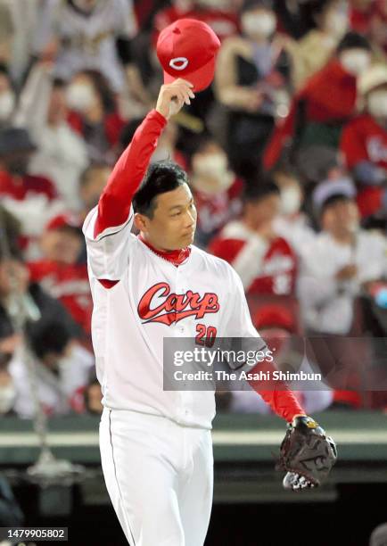 Ryoji Kuribayashi of the Hiroshima Carp reacts after allowing Yusuke Oyama of the Hanshin Tigers a RBI double in the ninth inning at Mazda Zoom-Zoom...