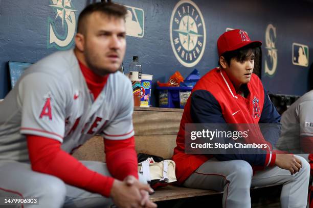 Mike Trout and Shohei Ohtani of the Los Angeles Angels look on during the first inning against the Seattle Mariners at T-Mobile Park on April 04,...