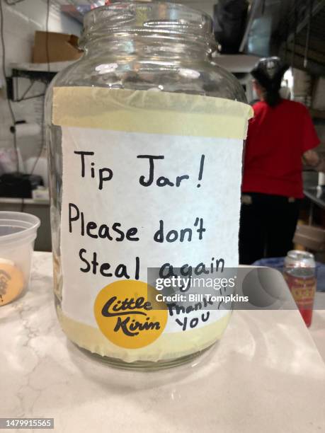 February 22: Sign on tip jar that reads 'Tip Jar! Please don't Steal again Thank you' on February 22nd, 2023 in New York City.