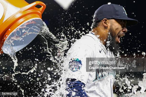 Ty France doouses Teoscar Hernandez of the Seattle Mariners with water after beating the Los Angeles Angels 11-2 at T-Mobile Park on April 04, 2023...