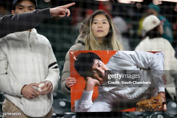Shohei Ohtani of the Los Angeles Angels fan looks on after the game between the Seattle Mariners and the Los Angeles Angels at T-Mobile Park on April...
