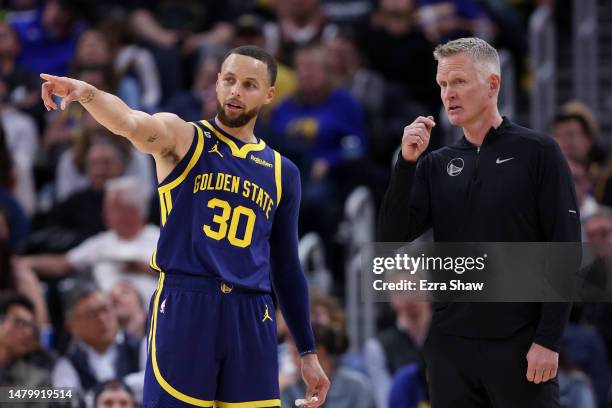 Stephen Curry of the Golden State Warriors talks to head coach Steve Kerr during their game against the Oklahoma City Thunder in the second half at...
