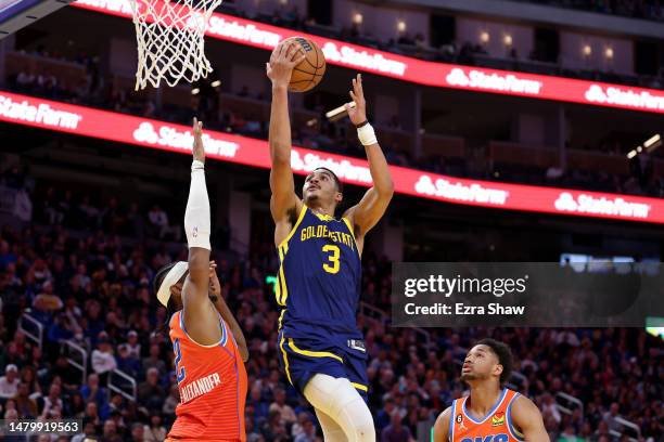 Jordan Poole of the Golden State Warriors shoots over Shai Gilgeous-Alexander of the Oklahoma City Thunder in the second half at Chase Center on...