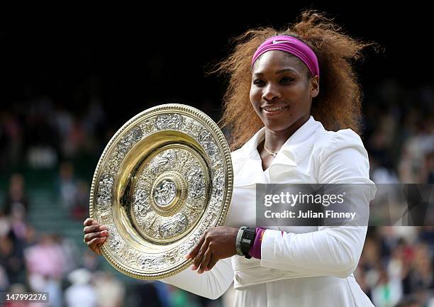 Serena Williams of the USA lifts the winners trophy and celebrates after her Ladies’ Singles final match against Agnieszka Radwanska of Poland on day...