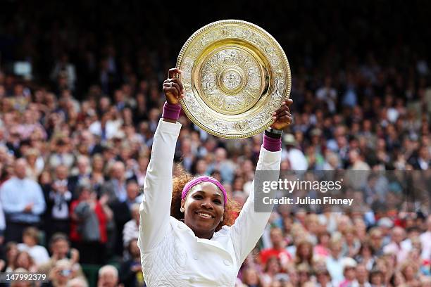 Serena Williams of the USA lifts the winners trophy and celebrates after her Ladies’ Singles final match against Agnieszka Radwanska of Poland on day...