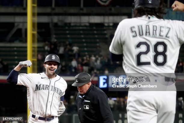 Pollock of the Seattle Mariners celebrates his two run home run with Eugenio Suarez during the fifth inning against the Los Angeles Angels at...