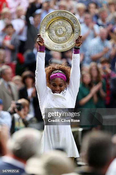 Serena Williams of the USA lifts the winners trophy and celebrates after her Ladies’ Singles final match against Agnieszka Radwanska of Poland on day...