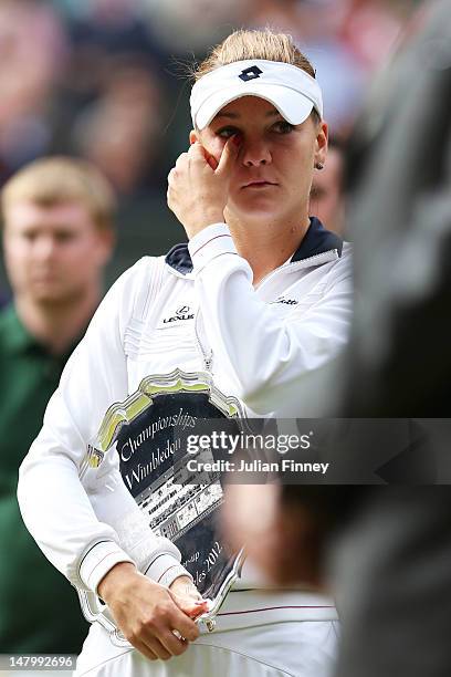 Runner-up Agnieszka Radwanska of Poland wipes away her tears after losing her Ladies’ Singles final match against Serena Williams of the USA on day...