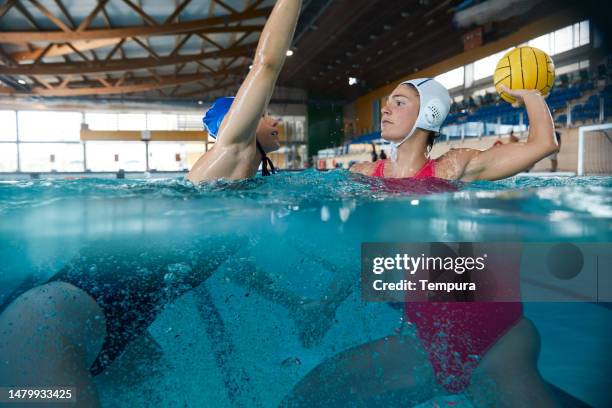 professional female water polo match in action - sport event stock pictures, royalty-free photos & images