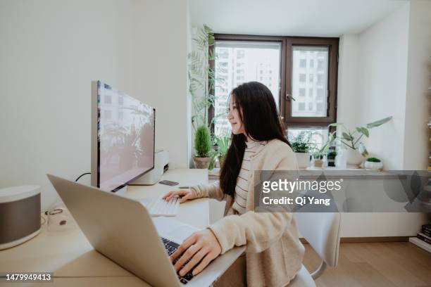 asian businesswoman using computer in home office - wide angle ストックフォトと画像