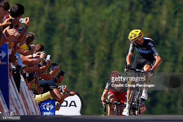 Christopher Froome of Great Britian riding for Sky Procycling takes a look back at Cadel Evans of Australia riding for BMC Racing as Froome sprinted...
