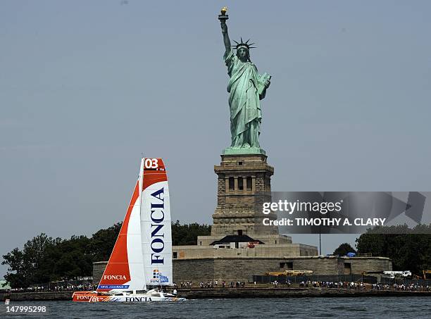 Foncia passes the Statue of Liberty at the start in the KRYS Ocean Race near lower Manhattan on July 7, 2012 in New York. Foncia is one of five...