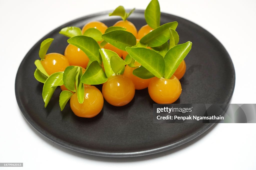 Orange jelly on a black plate