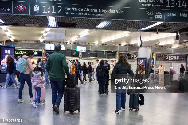 Several people with suitcases at Almudena Grandes-Atocha Cercanias station, on April 5 in Madrid, Spain. Renfe is offering nearly 2 million AVE,...