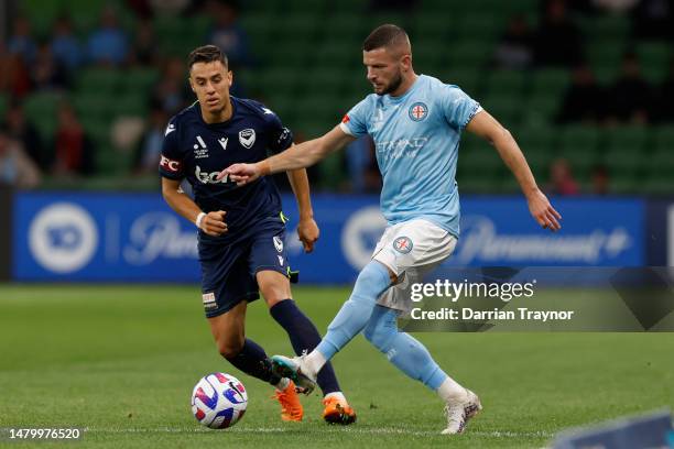 Chris Ikonomidis of Melbourne Victory competes with Valon Berisha of Melbourne City during the round eight A-League Men's match between Melbourne...