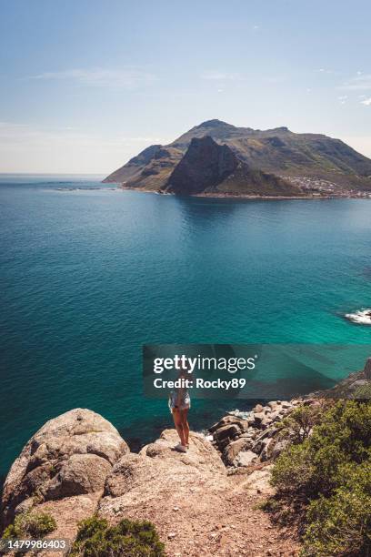 female tourist at chapman's peak drive near cape town, south africa - chapmans peak stock pictures, royalty-free photos & images