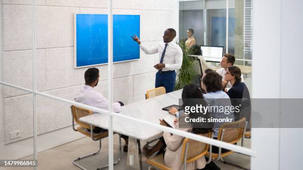 businessman giving presentation with graph - medium group of people stock pictures, royalty-free photos & images