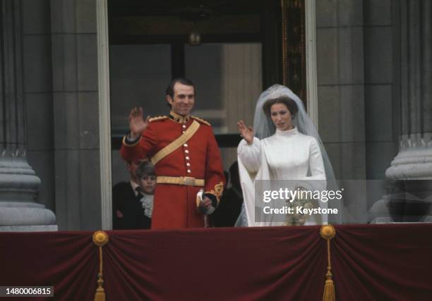 British equestrian Captain Mark Phillips and his wife, British Royal Princess Anne wave from the balcony of Buckingham Palace in Westminster, London,...