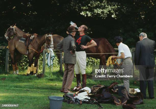 British Royal Prince Philip, Duke of Edinburgh, enjoys a drink between chukkas at Cowdray Park Polo Club, in the grounds of Cowdray Park, West...
