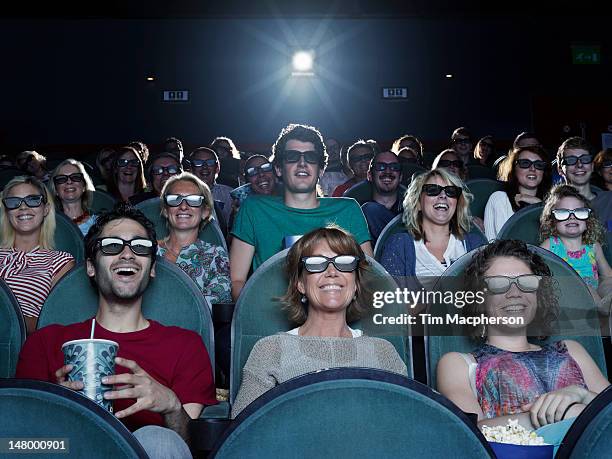 people watching a movie at a theater - kinoleinwand stock-fotos und bilder